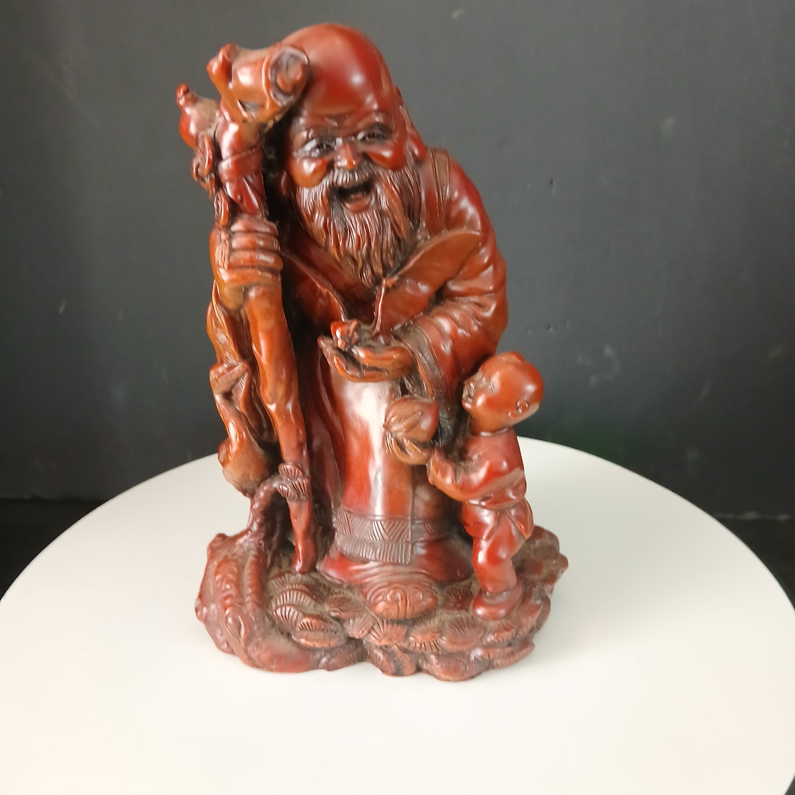 Vintage Chinese Red Resin Figure of an Immortal with a Child and a Wading Bird