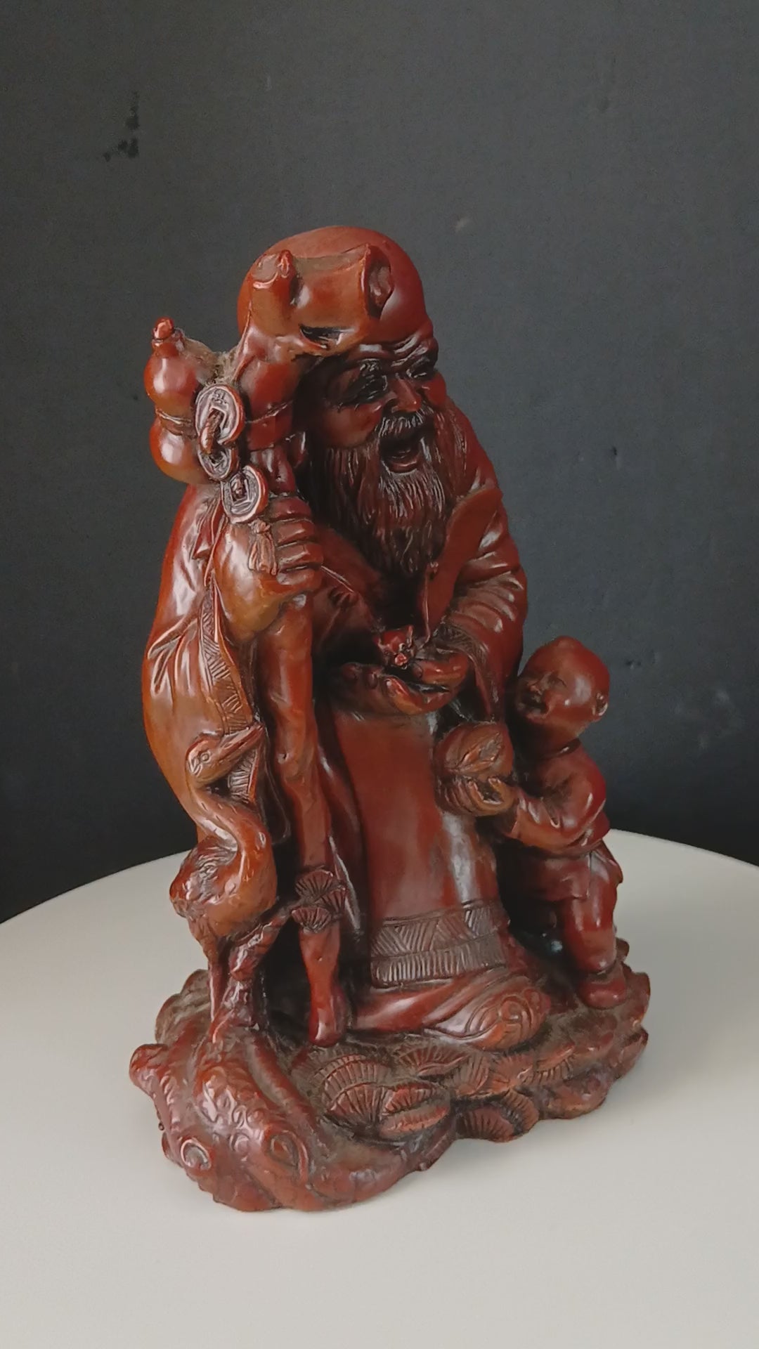 Vintage Chinese Red Resin Figure of an Immortal with a Child and a Wading Bird
